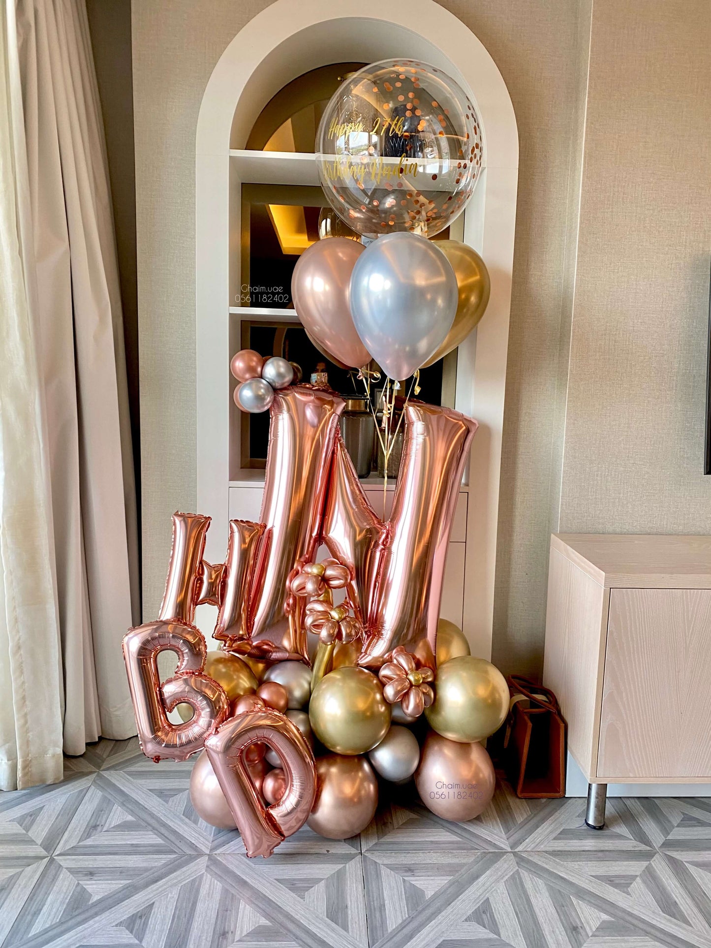 Rose gold, gold, and silver balloon arrangement with letter balloons, helium balloons, and confetti bubble balloon