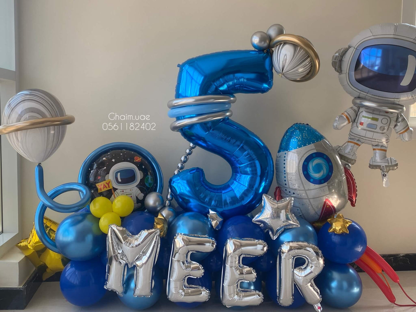 Space-themed birthday balloon decor with planets and rockets for premium kids party in Dubai.