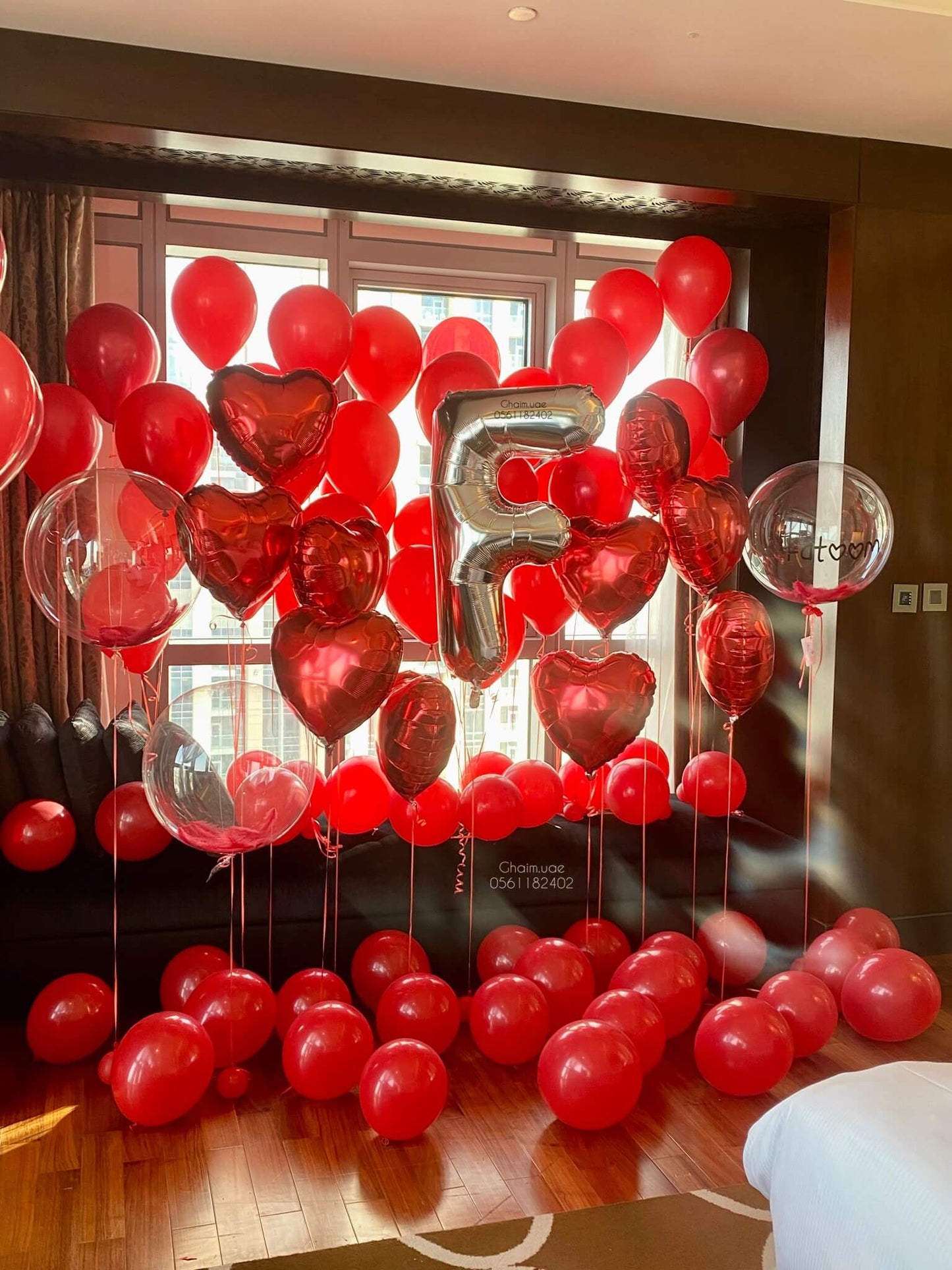 Romantic red heart balloon room decor with roses and candles luxury Dubai UAE