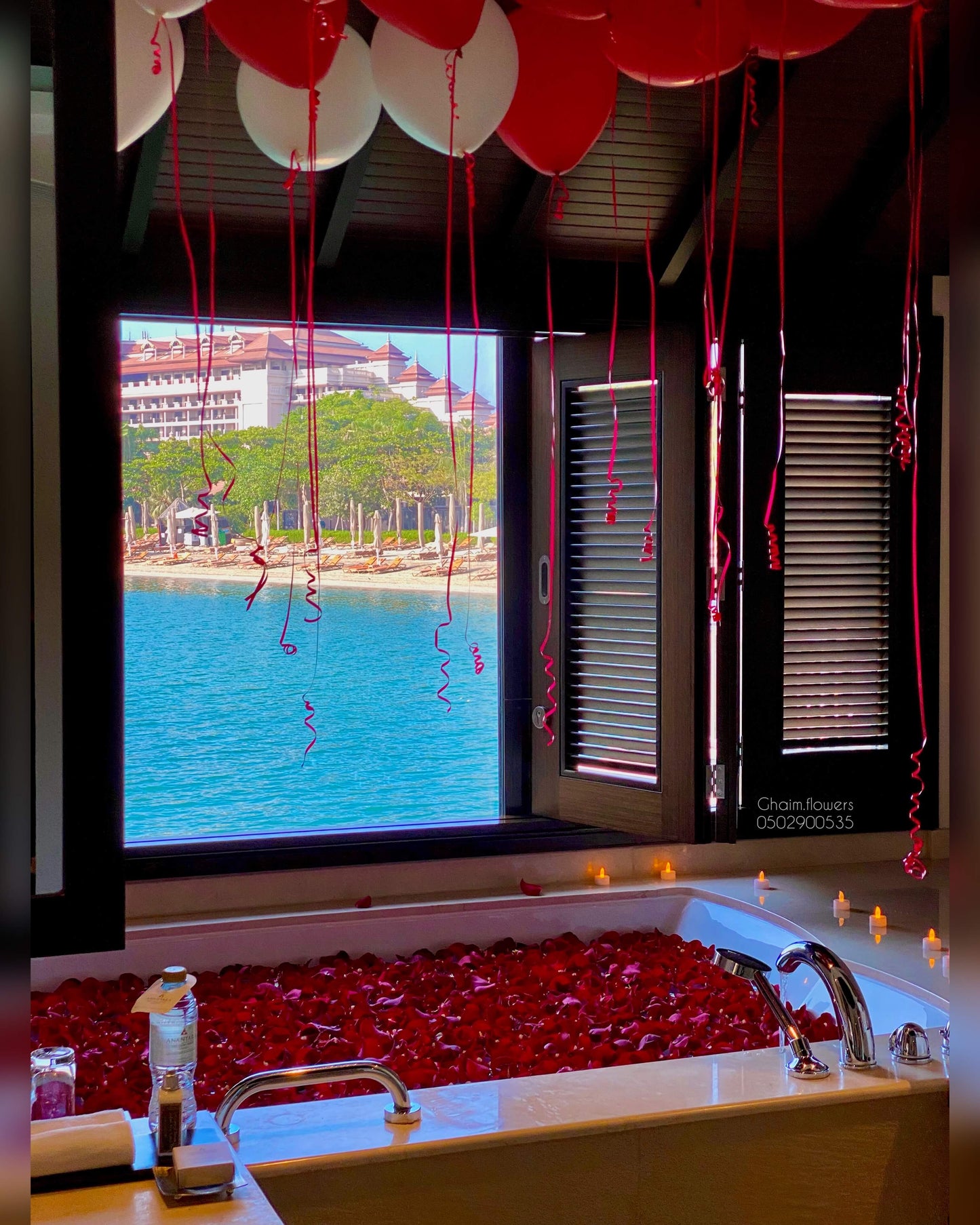VIP romantic birthday setup with red and gold balloons, rose petals, luxury bathtub decor Dubai UAE