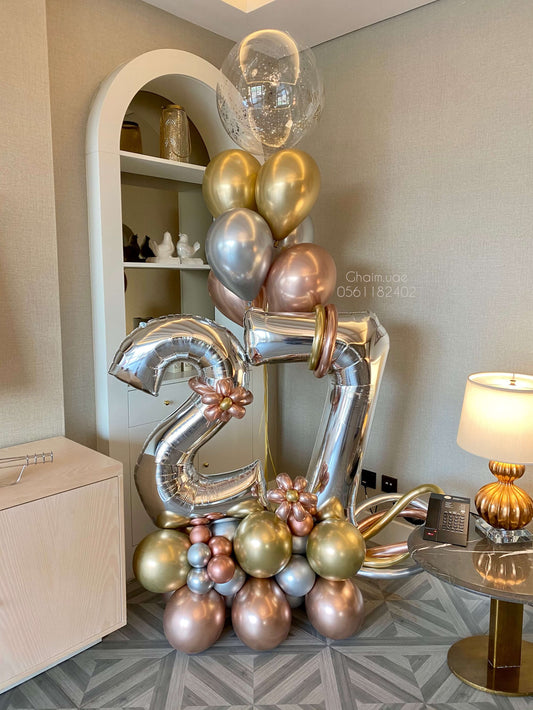 Metallic gold, silver, and rose gold number balloon arrangement with helium balloons and confetti bubble balloon