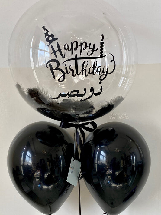Black helium balloon bouquet with custom text bubble balloon and feathers