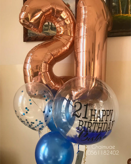 Rose gold number balloons with blue helium balloons, confetti balloons, and custom text bubble balloon