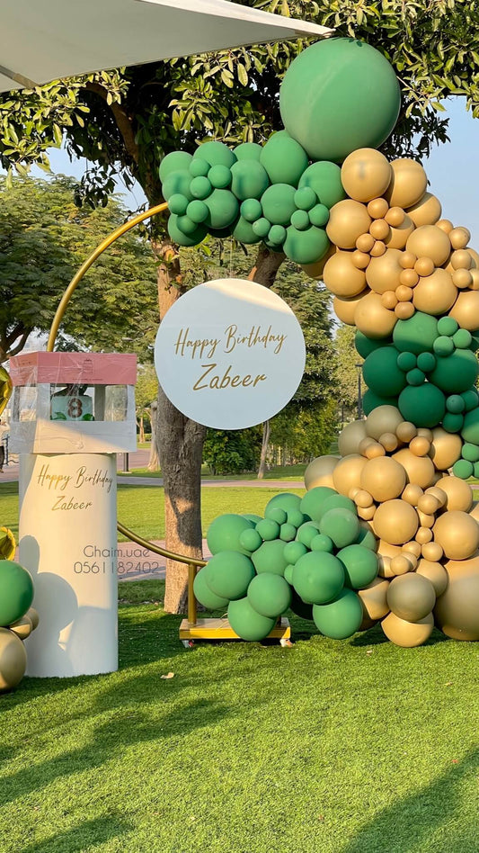  Green and gold birthday balloon backdrop with circular frame and custom text sign