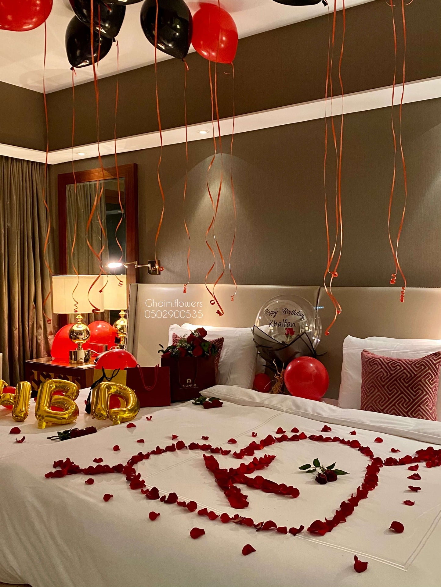 Luxury black and red birthday balloon decor with roses Dubai UAE